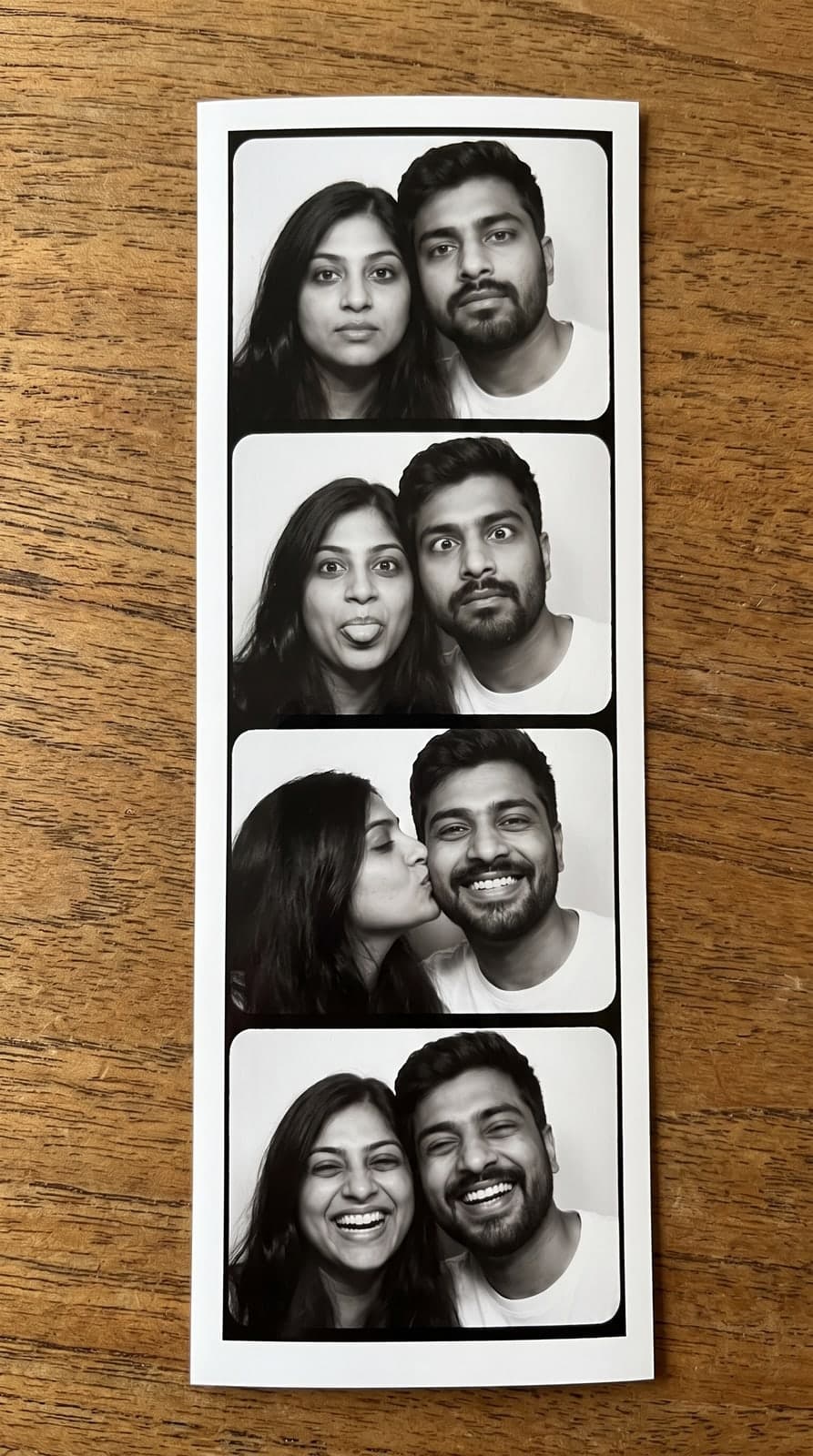 AI vintage black-and-white photo booth strip of a couple in four frames