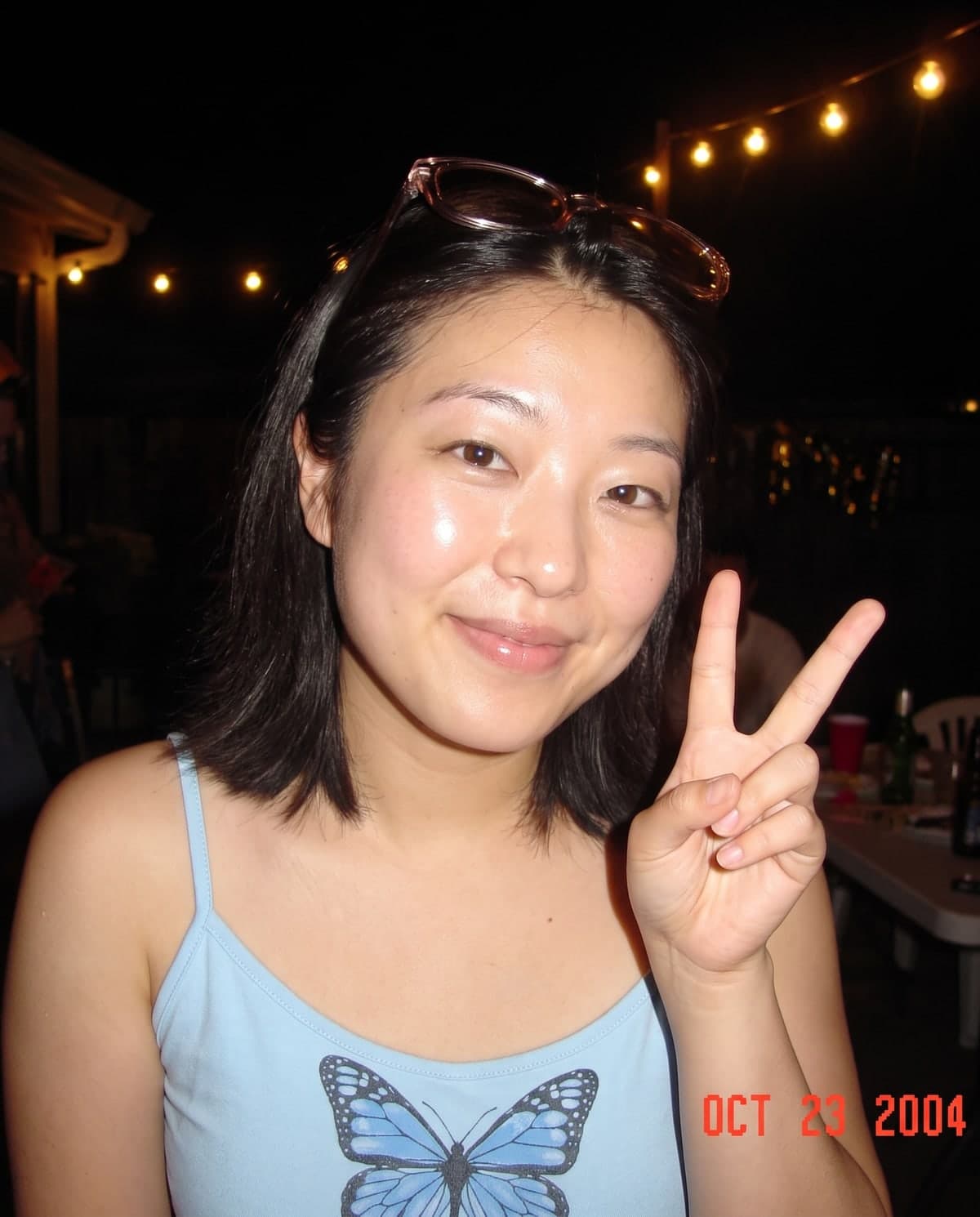 AI Y2K digital camera photo of a woman at a party with a harsh flash and a date stamp