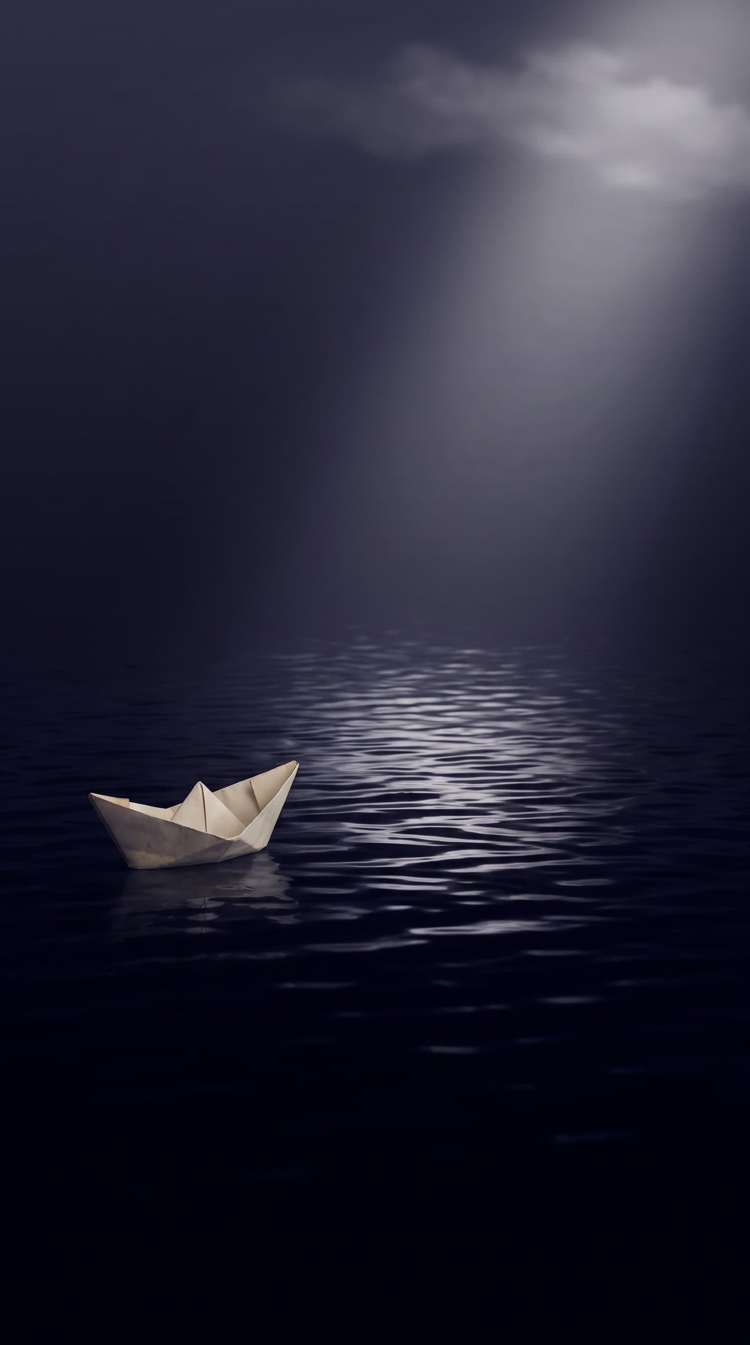 A small paper boat crossing an ocean of dark ink under moonlight